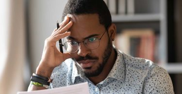 African American man studying report