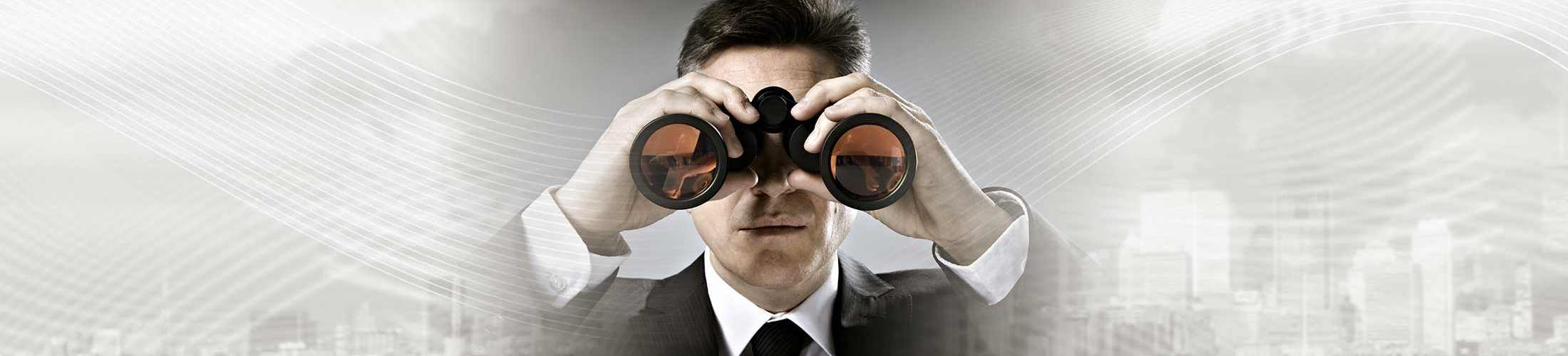 businessman with binoculars in cityscape