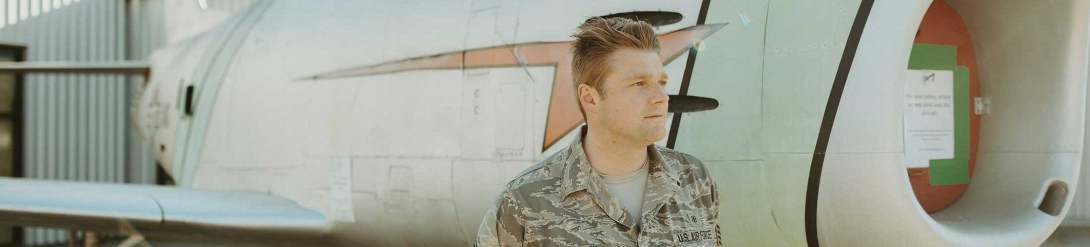 young air force man by airplane arizona