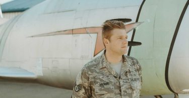 young air force man by airplane arizona