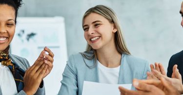 men and women celebrate at work