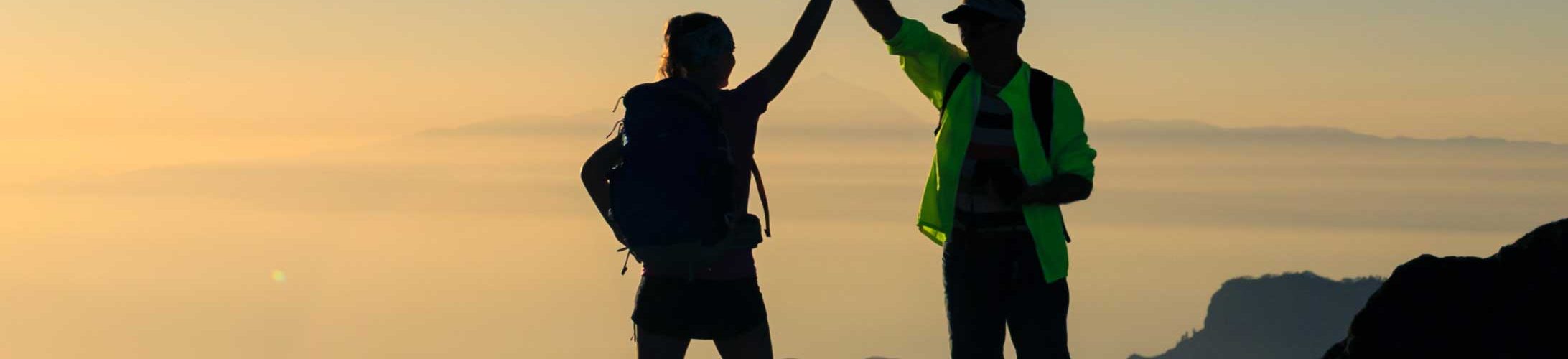 Man and woman celebrate on mountaintop