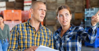 Warehouse workers collaborating