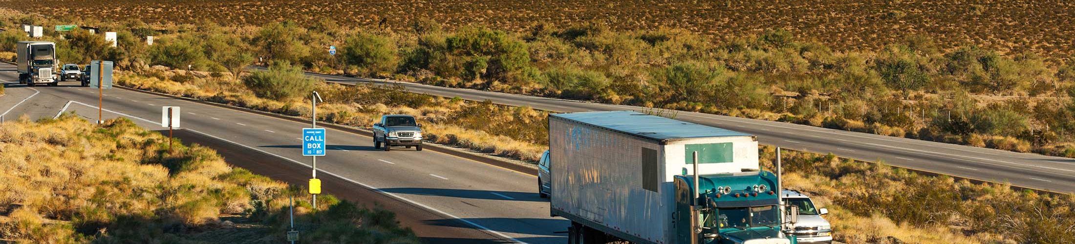 Cars and trucks on interstate highway through the desert