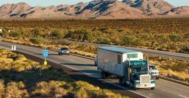 Cars and trucks on interstate highway through the desert