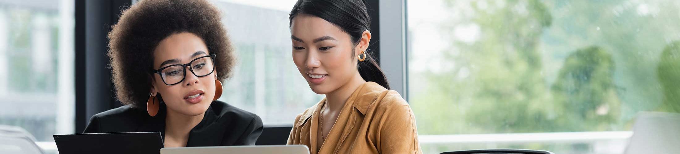 two women looking at computer