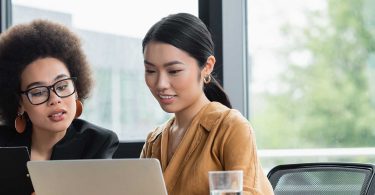 two women looking at computer