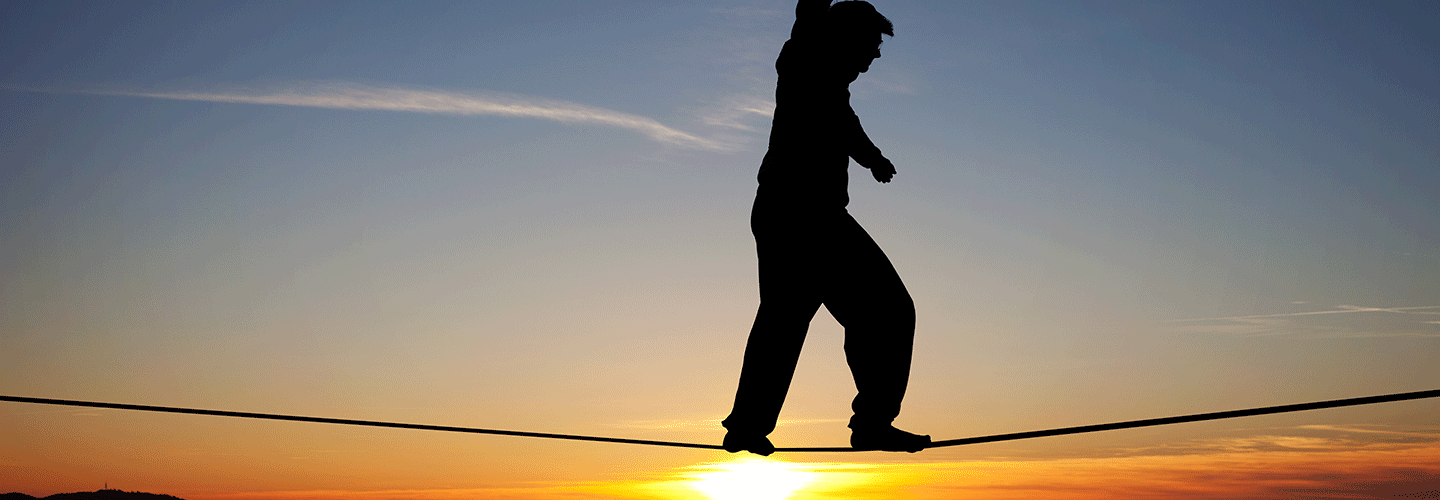 Person on highwire at sunrise