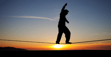 Person on highwire at sunrise