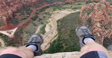 Man sitting above canyon