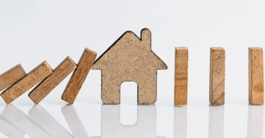 Domino blocks falling on house