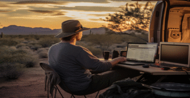 Man using computer in desert