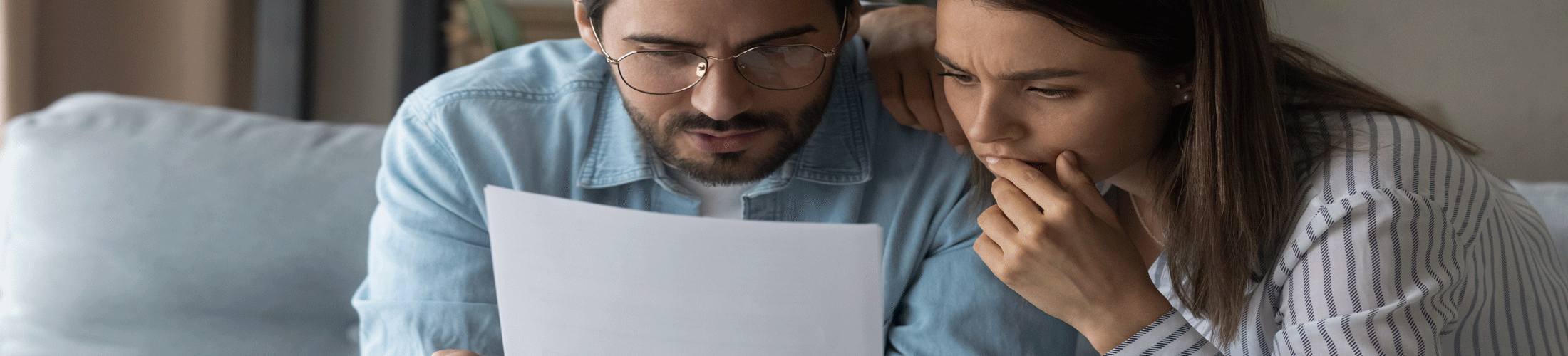 Couple looking at paper statement