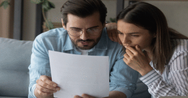 Couple looking at paper statement