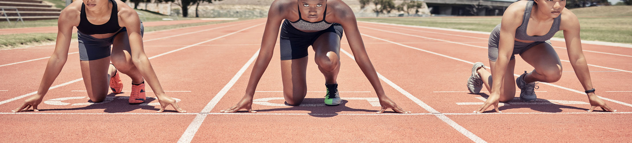 Three women track start line