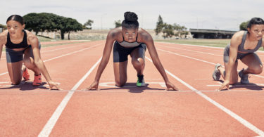 Three women track start line