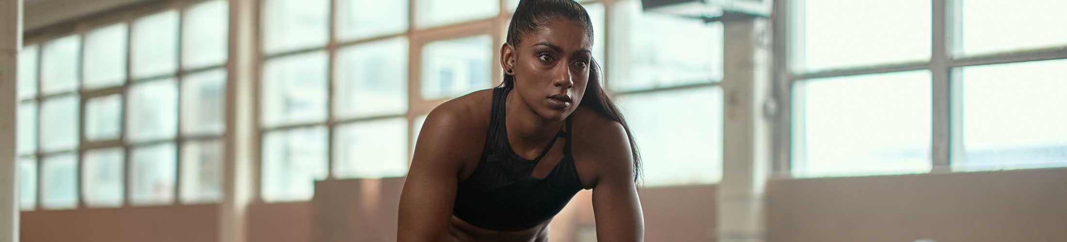 Woman sitting wood block in gym