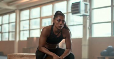 Woman sitting wood block in gym