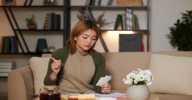 Woman viewing paper sitting living room