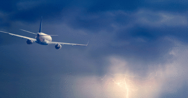 Plane flying lightning ocean