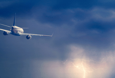 Plane flying lightning ocean