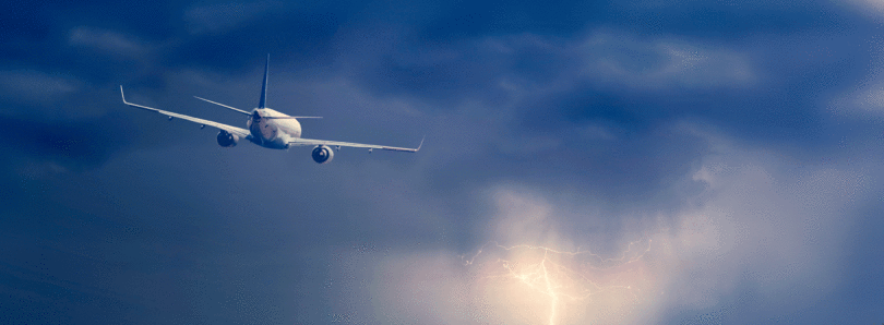 Plane flying lightning ocean
