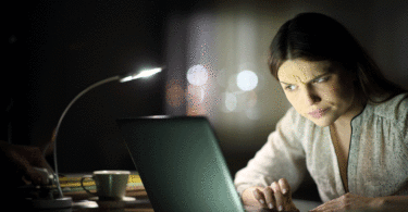 Woman staring computer confused