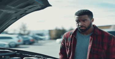 Man looking at car engine