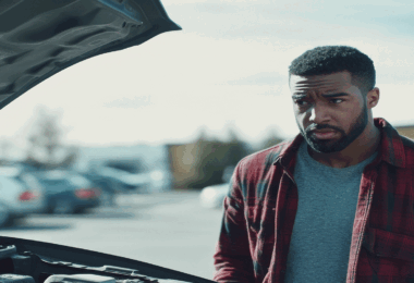 Man looking at car engine