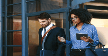 Man and woman walking out of an office building