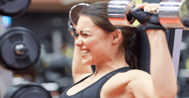 Woman lifting heavy weights