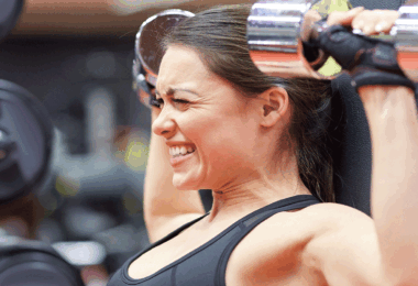 Woman lifting heavy weights